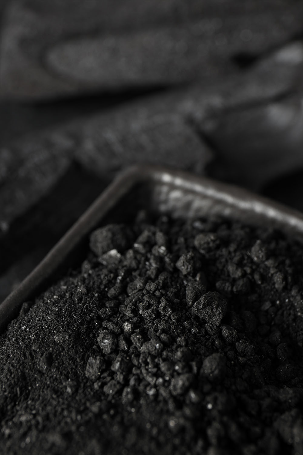 A blacksmith hardens steel at high temperature in a homemade furnace in the village.