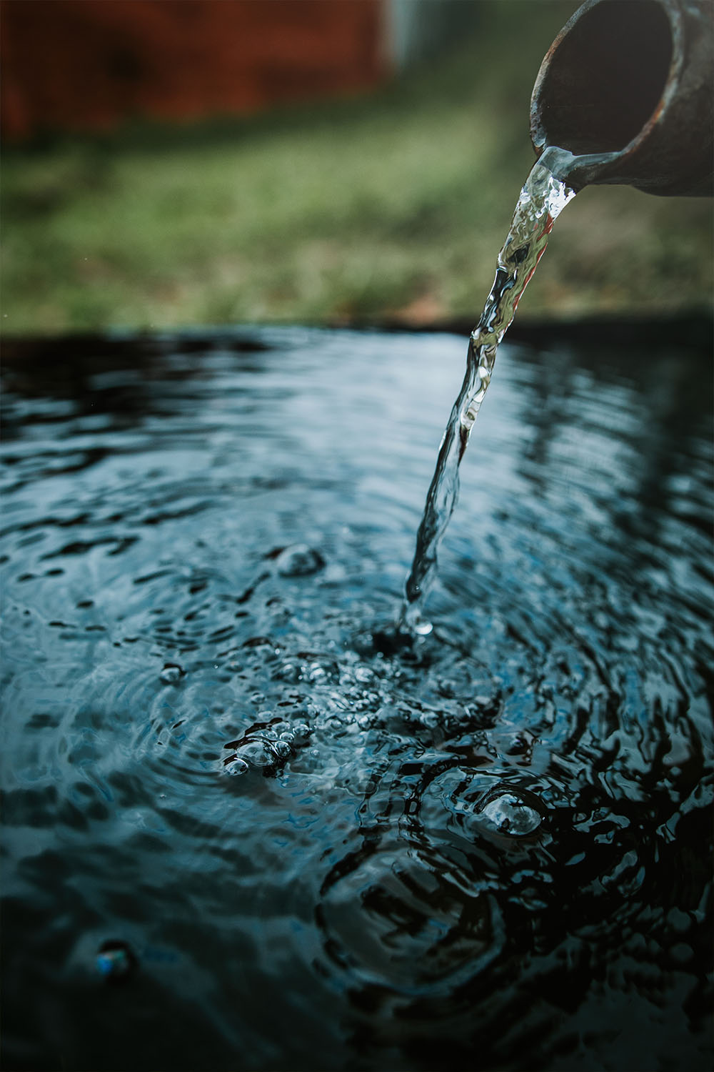 A blacksmith hardens steel at high temperature in a homemade furnace in the village.